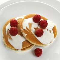 Pancakes with cream and fresh raspberries