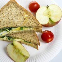 Egg and salad sandwich with tomatoes and apple