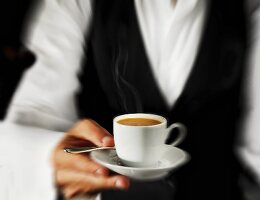 Waiter serving espresso