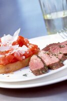 Close-up of lamb fillet with tomato on toast