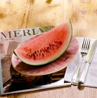 Piece of watermelon on serving plate, elevated view