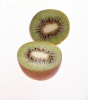 Two halves of kiwi fruit on white background
