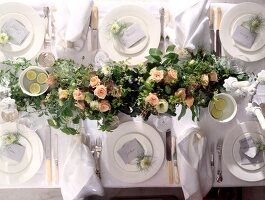 Table set with plates, cutlery and lush flower arrangement