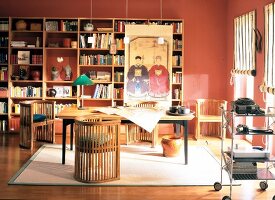 Asian-style study room with teak chairs, large table and book shelves