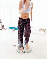 Woman exercising on aero-step cushion