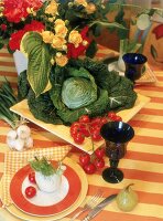 close-up eines angedeckten Sommertisches, gelborange, Gemüsedeko