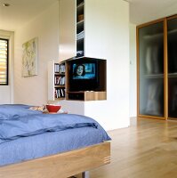 View of bedroom with parquet flooring and television in niche
