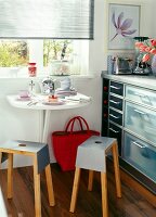 Space saving kitchen with wall folding table and stackable iron stool