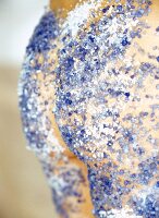 Close-up of woman's buttock covered with blue and white sea salt
