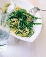 Spaghetti with green beans and pesto sauce on plate