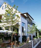 White semi-detached house on small plot with windows