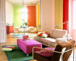 Colourful living room with sofa, table, floor lamp and cushions