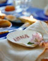 Shell shaped place card on napkin, maritime decoration