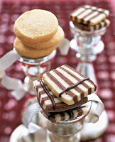 Slices of black and white striped cakes and heidesand on sliver stand