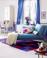 Blue chaise lounge with pillows in living room