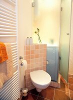 View of bathroom with tiled wall and towel warmer