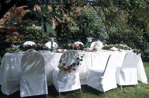Outdoor table and chair decorated in white