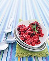 Close-up of beetroot risotto with wheat in serving bowl