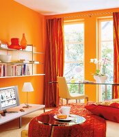 Bookcase and desk with orange wall in bedroom