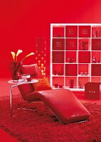 Red relaxing chair with vase and other decorations in living room