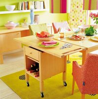 Serving birch standing next to dining table in colourful living room