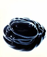 Close-up of dab of black hair dye on white background