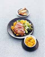 Duck breast, mango chutney and buckthorn bread on plate