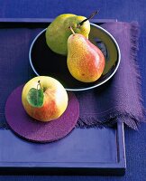 Apple and pears on purple background