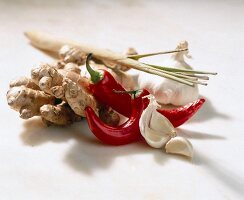 Chilies, ginger, lemongrass and garlic on white background