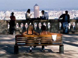 Women sitting on Fourviere hill overlooking city of Lyon in France