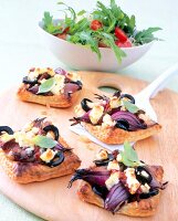 Red onion tart with baked feta on chopping board