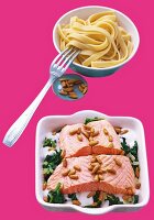 Salmon fillet with spinach served with bowl of noodles