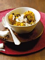 Yellow lentil and vegetable stew in a white bowl