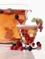Berry punch with garnishing of various berries in glass