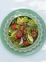 Bread salad with tomatoes and olives in bowl