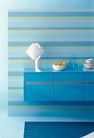 Blue sideboard with shelves and white crockery