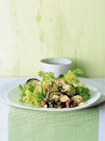 Frisee salad with roasted vegetables and mushrooms on plate