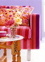 Arabic style coffee table against floral patterned cushions on striped sofa