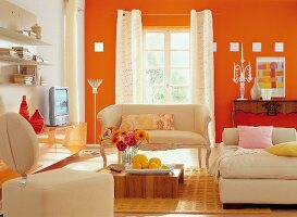 Baroque orange living room with beige sofa and white curtains