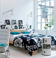 Modern bedroom with black and white bedspread and window