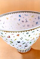 Close-up of glass bowl with multi-coloured patterns