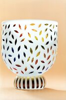 Close-up of mini cup with multi-coloured leaf motifs