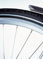 Close-up of aluminium rims and stainless steel spokes of touring bike 