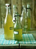 Quince syrup in old bottles on wooden table