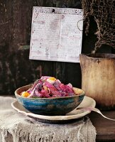 Herring salad with beetroot, potatoes, apples and onions in bowl
