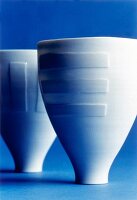 Close-up of porcelain cups on blue background