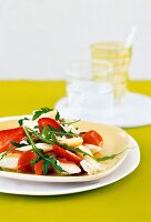 Asparagus salad with aromatic strawberries, arugula and parmesan cheese on plate