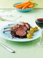 Rack of lamb with herb, potatoes and balsamic carrots on plate