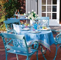 Blue table set on garden terrace