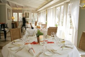 Interior of restaurant with laid tables and bar in Germany